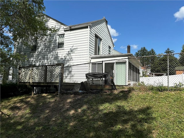 back of house with a yard and fence