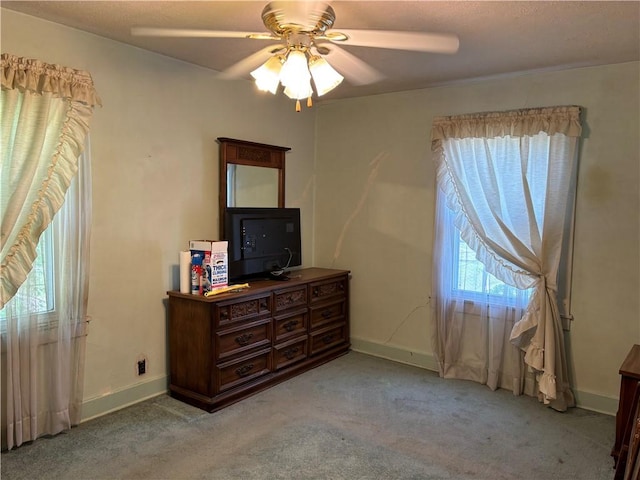 carpeted bedroom featuring a ceiling fan and baseboards