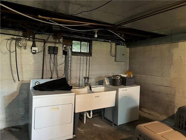 washroom with electric panel, laundry area, independent washer and dryer, and a sink