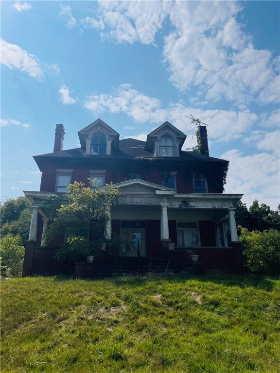 view of front of house with a porch and a front lawn