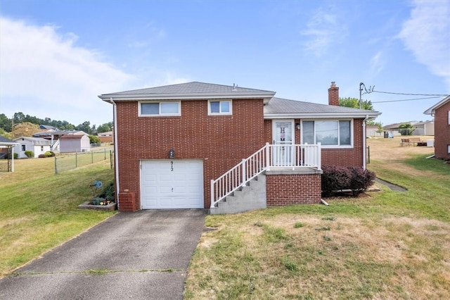 view of front of property with a front yard and a garage