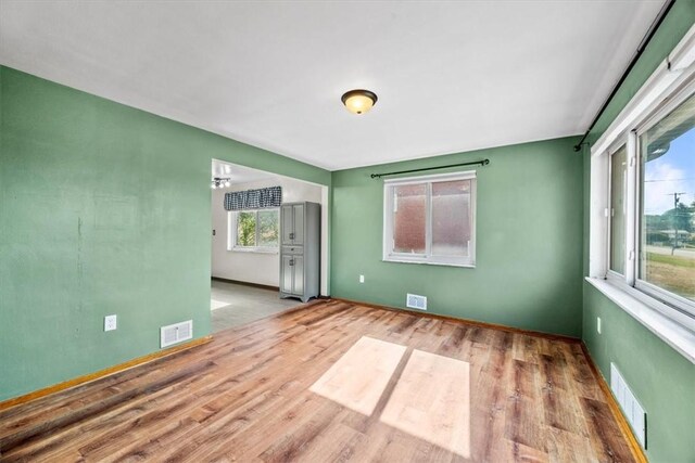 spare room with light wood-type flooring