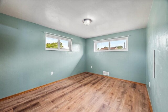 unfurnished room with light wood-type flooring and plenty of natural light