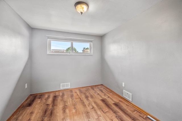 empty room with hardwood / wood-style floors