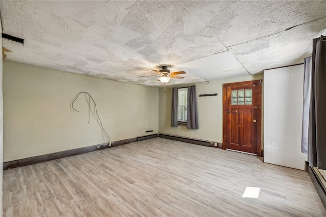 interior space with ceiling fan, light wood-type flooring, and a baseboard radiator