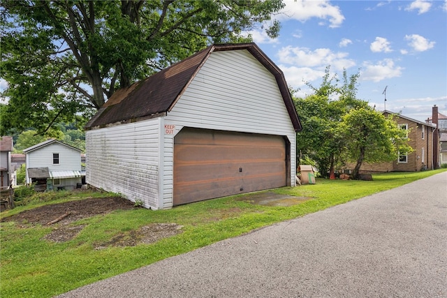 garage featuring a lawn