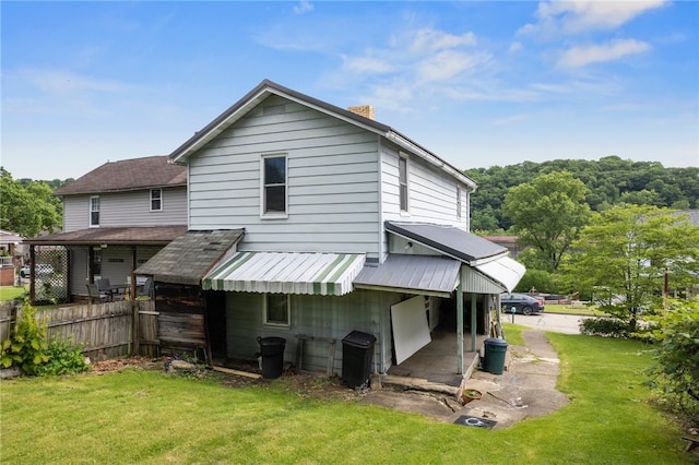 rear view of house with a lawn