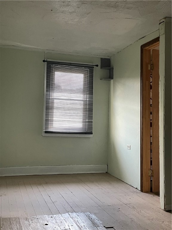 spare room featuring wood-type flooring