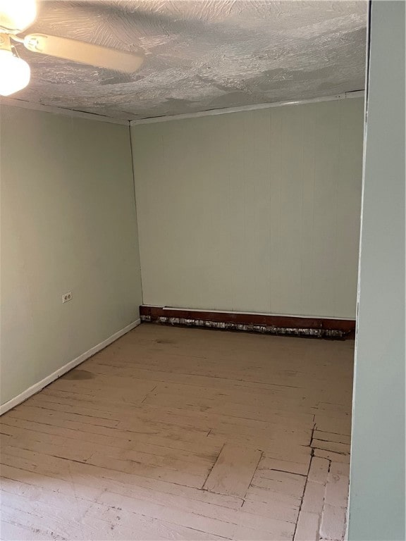 unfurnished room with hardwood / wood-style floors and a textured ceiling