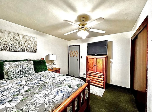 bedroom featuring a textured wall, a textured ceiling, dark carpet, and ceiling fan