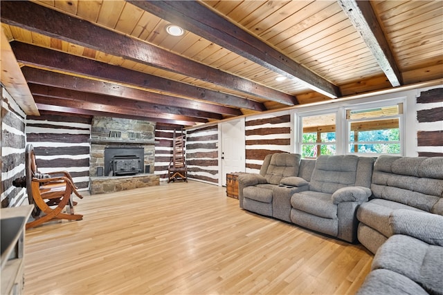 living room featuring wood ceiling, light hardwood / wood-style floors, beamed ceiling, and a fireplace