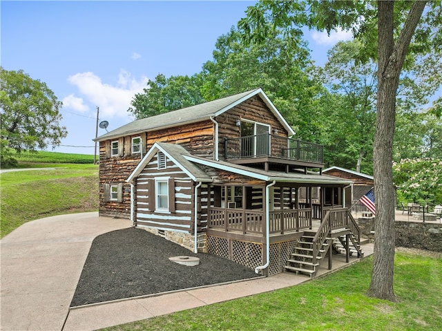 log cabin with a patio, a front lawn, and a deck