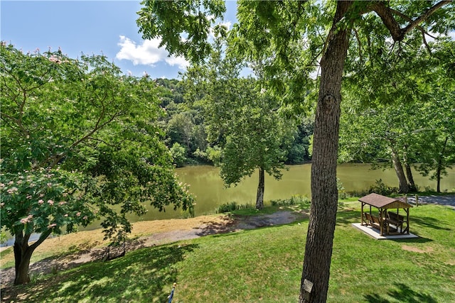 surrounding community with a gazebo, a yard, and a water view