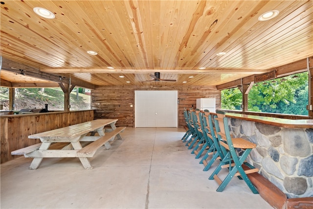 misc room featuring log walls and wood ceiling