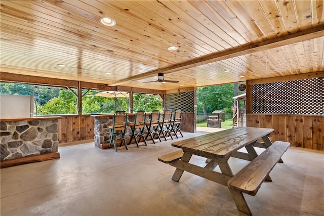 dining space with wood ceiling and ceiling fan