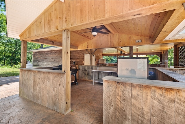 view of patio featuring ceiling fan and an outdoor bar