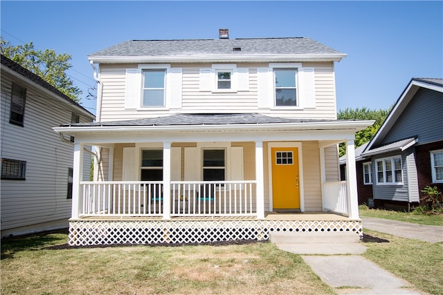 view of front of property featuring a front yard and a porch