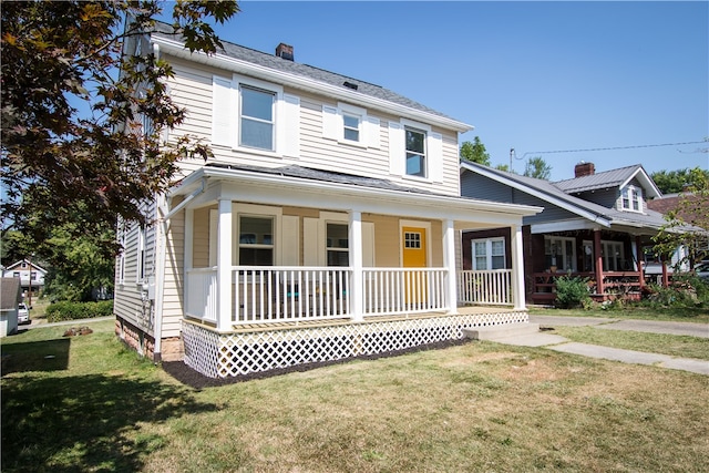 view of front facade featuring covered porch and a front yard