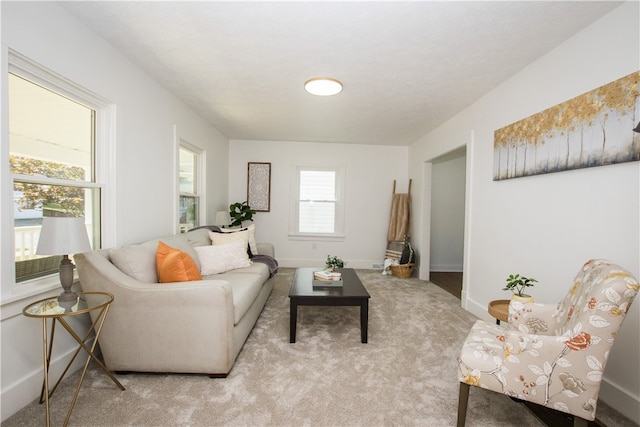 carpeted living room featuring plenty of natural light