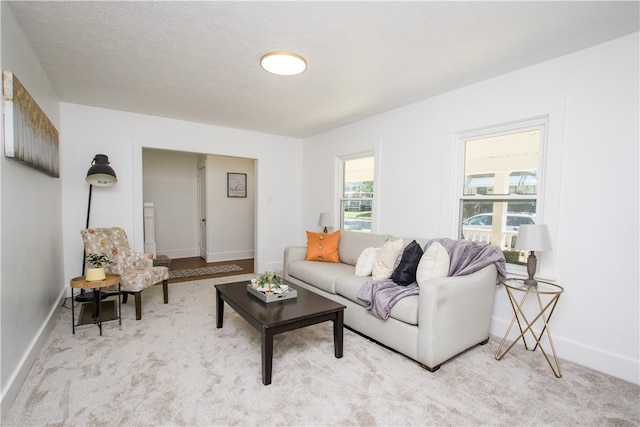 living room with light carpet and a textured ceiling