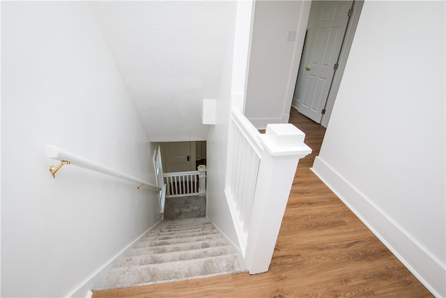 staircase with wood-type flooring