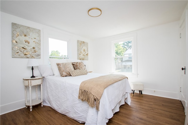 bedroom with dark hardwood / wood-style flooring