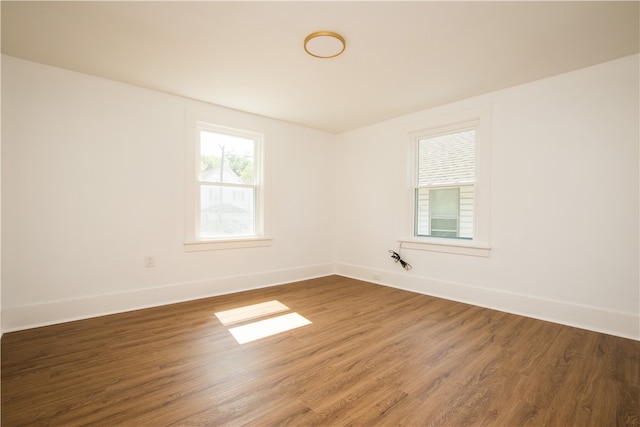 unfurnished room with hardwood / wood-style flooring