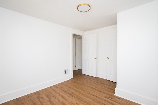 unfurnished room featuring hardwood / wood-style floors