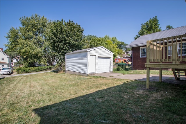 view of yard featuring an outbuilding and a garage