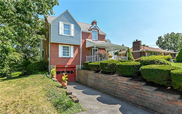 view of front of property with a garage and a front lawn