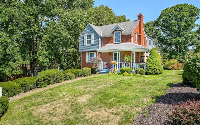 view of front of house featuring covered porch and a front yard