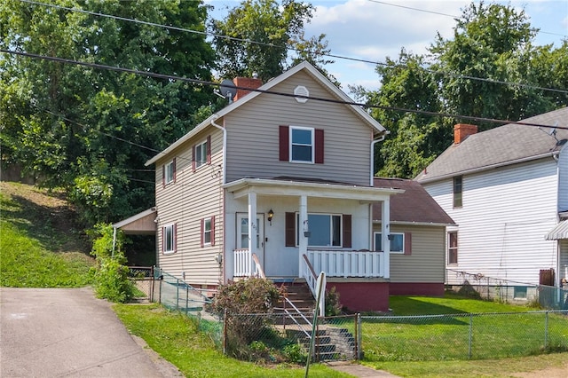 view of front of home with a front yard and a porch