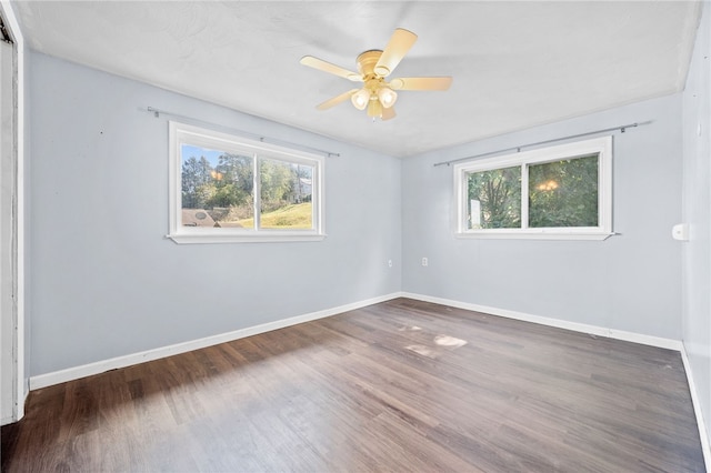 empty room featuring dark wood-type flooring and ceiling fan