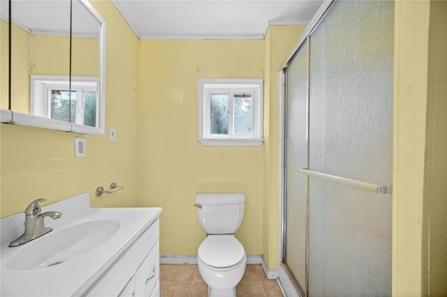 bathroom featuring a shower with door, vanity, toilet, and tile patterned floors