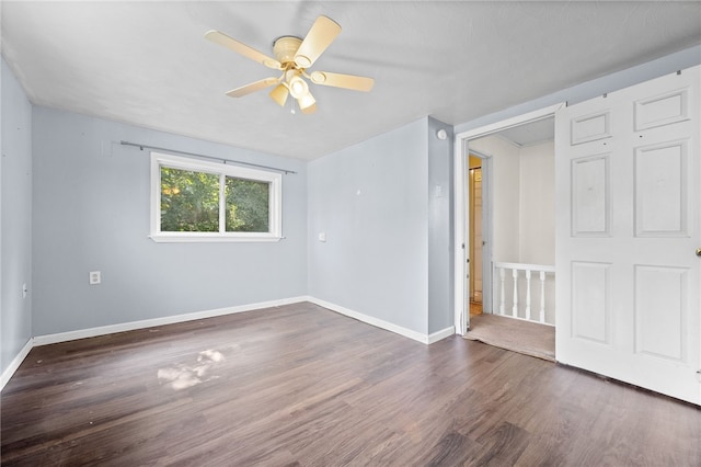 unfurnished room with dark hardwood / wood-style flooring and ceiling fan