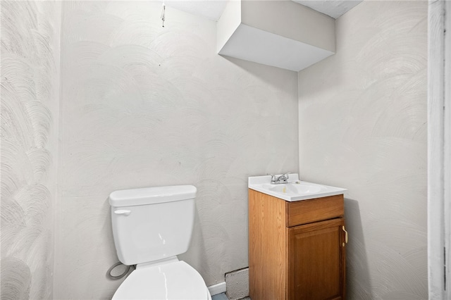 bathroom featuring toilet and vanity