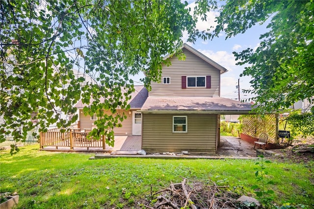 back of property with a wooden deck and a yard