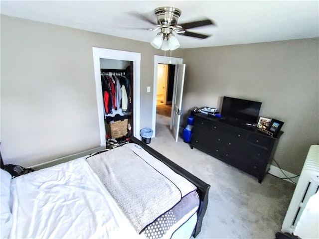 carpeted bedroom with ceiling fan, a closet, and radiator