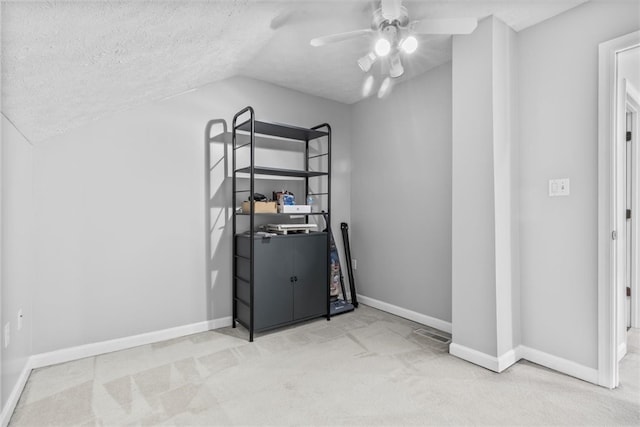 bedroom with light carpet, a textured ceiling, ceiling fan, and lofted ceiling