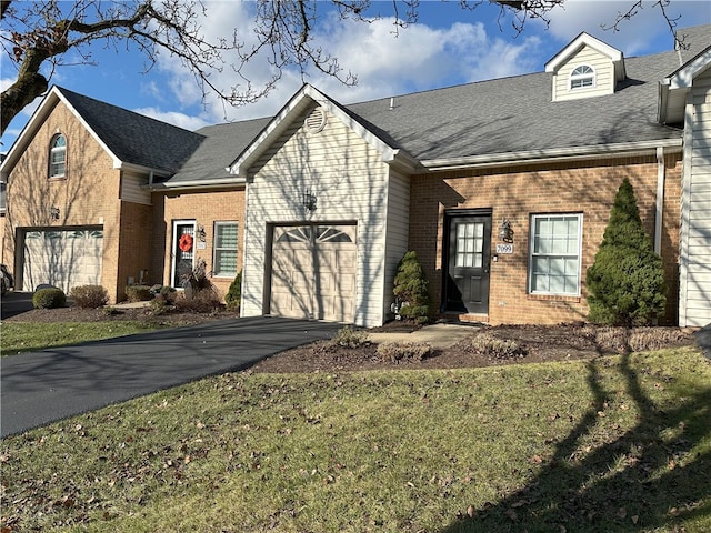 view of front of property featuring a front yard and a garage