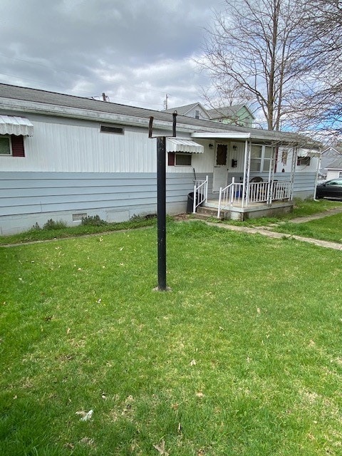 rear view of property with a yard