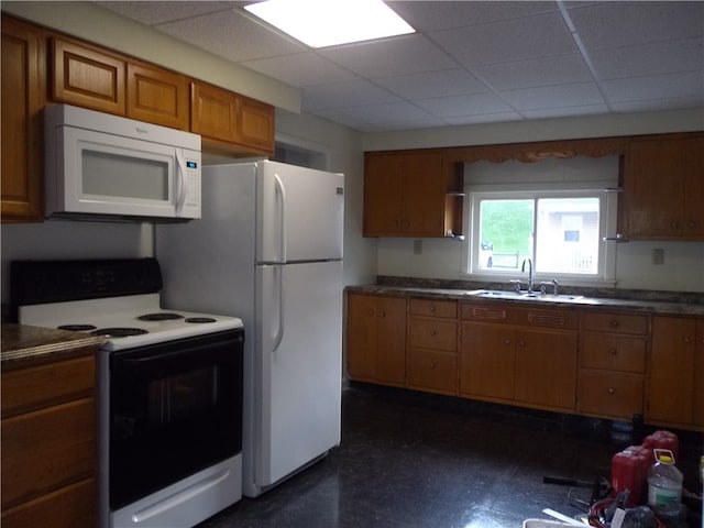 kitchen featuring sink, a paneled ceiling, and white appliances