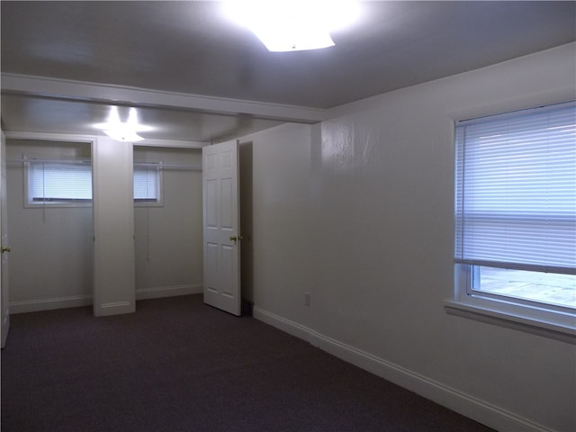 basement featuring dark colored carpet