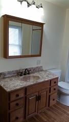 bathroom featuring toilet and vanity