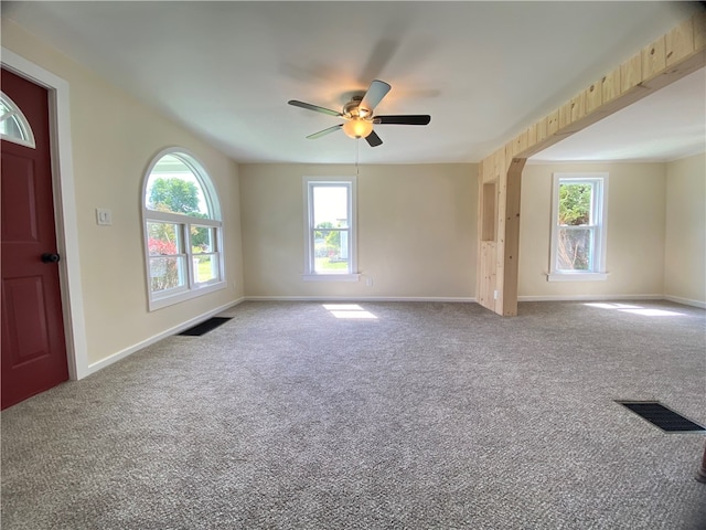 carpeted spare room with ceiling fan