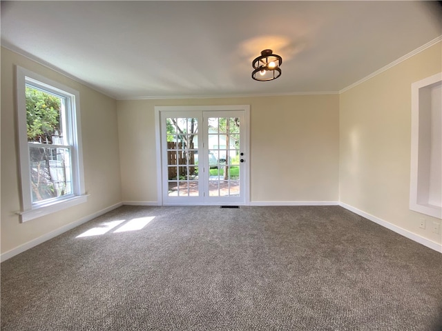 carpeted spare room with crown molding and french doors