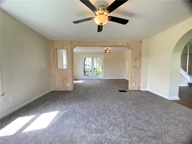 carpeted spare room with ceiling fan and french doors