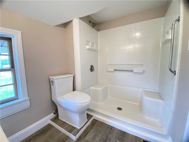 bathroom featuring toilet, walk in shower, and wood-type flooring