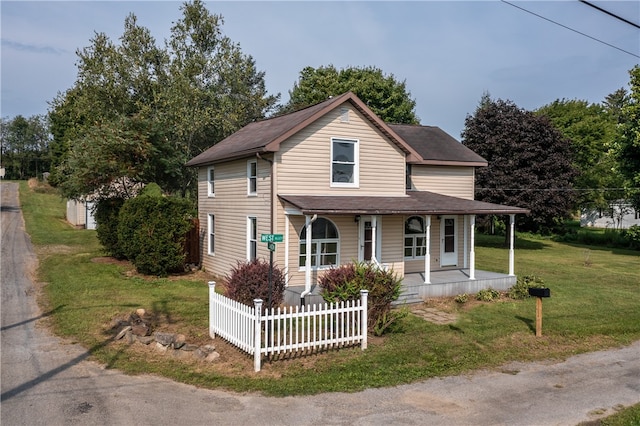 view of front of property with a porch and a front lawn