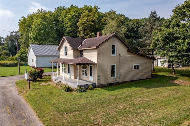 view of front of home featuring a front yard and covered porch